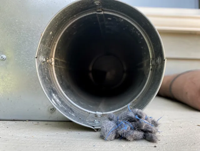 Calimesa Dryer Vent Cleaning technician using specialized equipment to clear severe dryer vent blockage in Calimesa